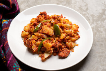 Potatoes with chorizo on a gray background.  Mexican food