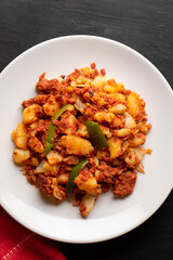 Potatoes with chorizo on a dark background.  Mexican food