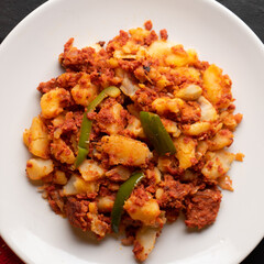 Potatoes with chorizo on a dark background.  Mexican food