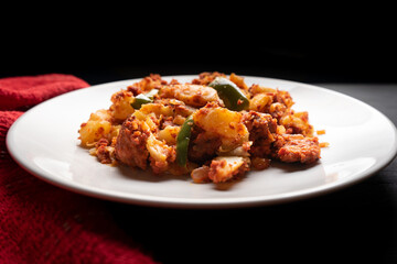 Potatoes with chorizo on a dark background.  Mexican food