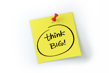 Think big written on yellow sticker note over white background