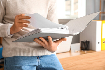 Young man working with documents in office