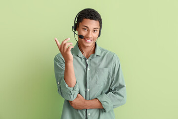 African-American technical support agent on color background