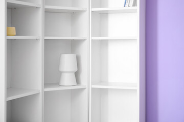 Modern shelf unit near color wall