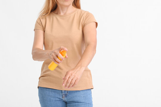 Mature Woman With Mosquito Repellent On Light Background