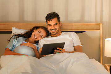 happy pregnant mother and husband having video chatting with friends