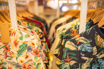 shirt and clothes for aloha summer hanging on a shelf © Mongkolchon
