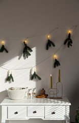 Table with Christmas decor in room