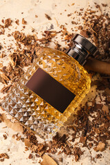 Stylish perfume bottle, cigar and tobacco on grunge background