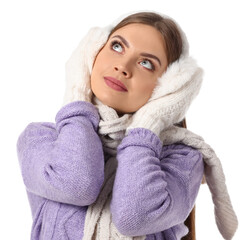 Beautiful young woman in warm winter clothes on white background