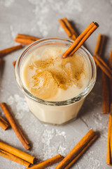Traditional eggnog cocktail on the rustic background. Christmas mood. Selective focus.
