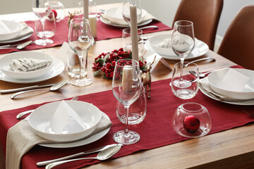 Festive table setting for Christmas celebration in dining room
