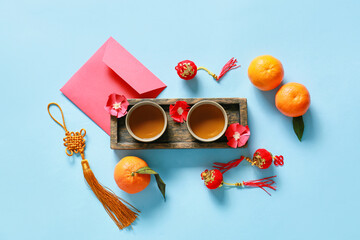 Red envelope with tea and Chinese symbols on color background. New Year celebration