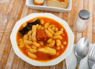 Delicious Fabada asturiana with stewed beans, pork, morcilla and chorizo. Famous authentic regional...