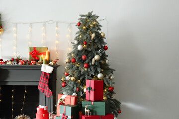 Christmas tree near decorated fireplace in living room