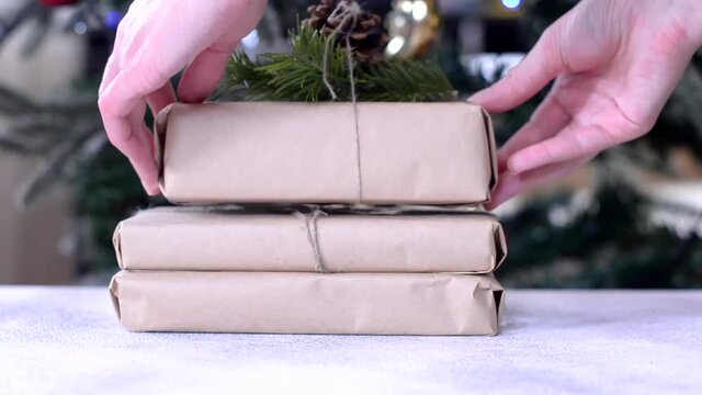 zero waste christmas gift decorated pine cone and fir branch with craft paper, no plastic holidays with lights garland christmas tree at home.