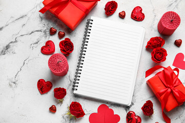 Romantic composition with empty notebook and gifts on white background