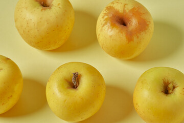 Yellow apple on pastel yellow background. Healthy apples.