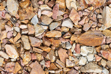 Large crushed stone for road construction close-up. Red rubble paving background.