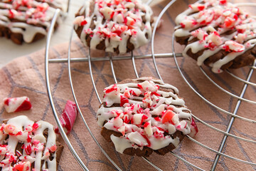 Grid with tasty candy cane cookies on table, closeup