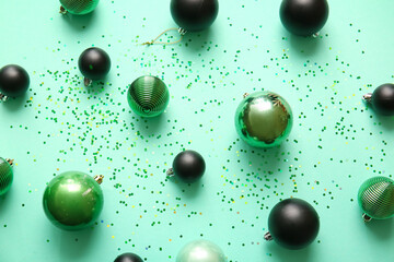 Stylish Christmas balls on green background