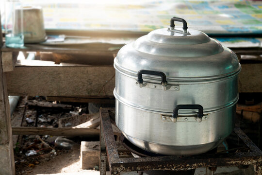 Steamed on a steel frame gas stove. Open-air cooking by locals in Thailand. - Powered by Adobe