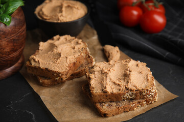 Fresh bread with delicious meat pate served on black table, closeup