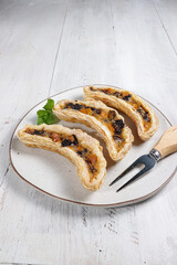 Pastry puff filling with bananas, cheese and chocolate shaped with banana molded or banana milk pastry. 