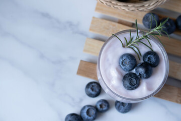 Fresh blueberry yogurt in a clear glass - Powered by Adobe