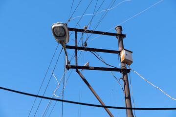 cable clutter on electric pole and street lamp