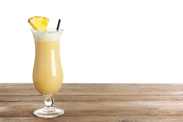 Tasty Pina Colada cocktail on wooden table against white background, space for text