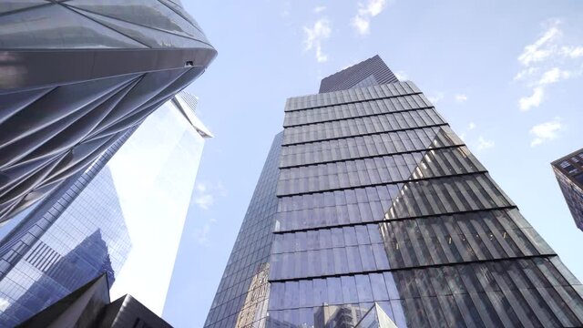 Business and finance concept, view looking up at modern office building architecture in the New York City with clear blue sky