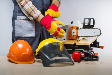 Craftsman puts protective gloves. Protective clothing used by builders.