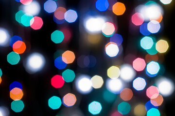 Obraz premium black abstract background with multicolored lights with bokeh in blur