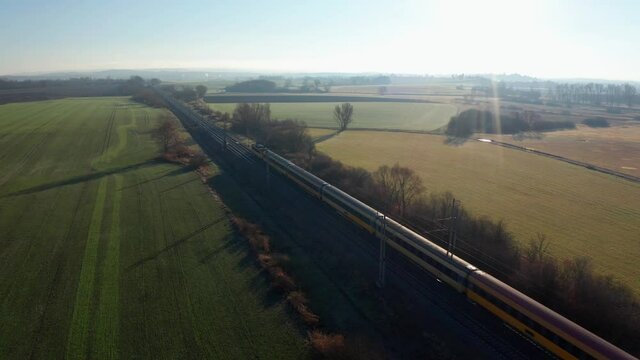 Aerial shot of two express trains passing by in Czech countryside railways