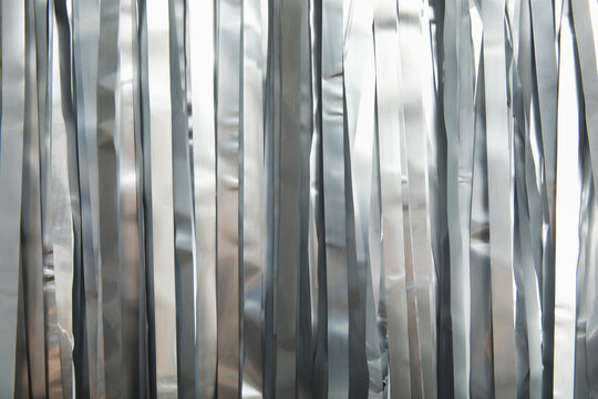 Shiny silver tinsel as background, closeup. Christmas decoration
