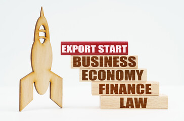 On the white surface there is a wooden rocket and planks, on the red plaque the inscription - EXPORT START