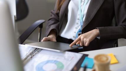 Businesswoman or financial consultant looking at digital tablet