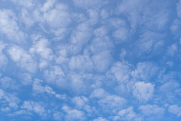 Fototapeta na wymiar White fluffy clouds on the background of the blue sky. Abstract background, wallpaper.