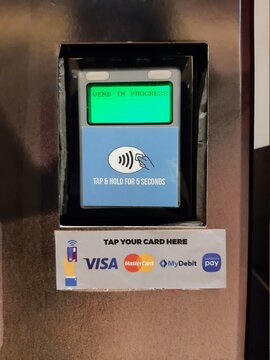 A picture with noise effect of paywave debit and credit card payment terminal at vending machine