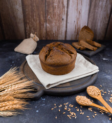 fresh bread and wheat on wooden cutting board