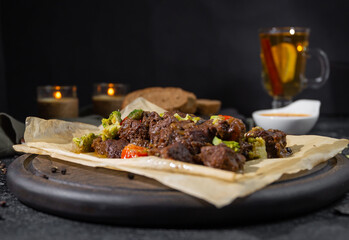 grilled beef with vegetables on wooden board
