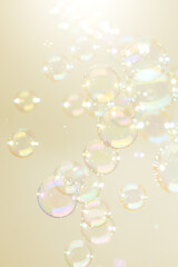 Beautiful Transparent Shiny Soap Bubbles Floating on Yellow Background