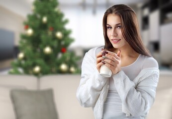 Portrait of positive lady smell aromatic coffee cup sit couch in house indoors with christmas x-mas atmosphere decoration wear jumper