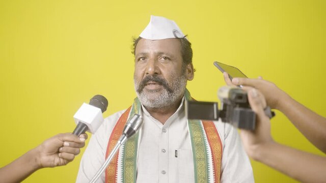 Indian politician angry on news media while reporter asking questions about development and corruption - concept of threaten, press conference and political hydrama.