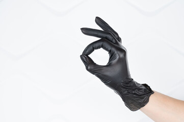 Hand ok sign, thumb and forefinger forming OK, hand in latex (medical) glove isolated on white. All is well concept
