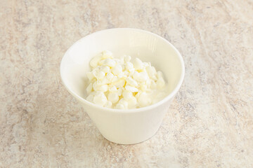 Grained cottage cheese in the bowl