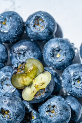Fresh wet blueberries on the marble table.