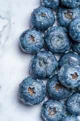 Fresh wet blueberries on the marble table.