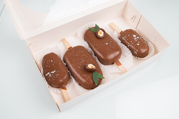 Chocolate cake pops in the form of ice cream on a stick. On a wooden stand, top view. Concept food, sweets.